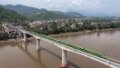 A bullet train runs on the China-Laos Railway's Luang Prabang cross-Mekong River super major bridge in Laos. Photo by Chen Chang/Xinhua.