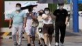 People walk on the street amid high temperatures. Photo by Xinhua.