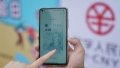 A staff member of the Bank of Communications demonstrates the use of the online wallet of digital RMB at the Happy Valley Beijing theme park in Beijing, capital of China. Photo by Xinhua/Chen Zhonghao.