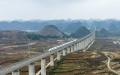 A high-speed train running along a section of the Shanghai-Kunming high-speed railway in Zhenning Buyi and Miao Autonomous County, southwest China's Guizhou Province. Photo by Chen Xi/Xinhua.