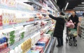 Consumers select dairy products at a supermarket in Xinle, north China's Hebei Province. Photo by Jia Minjie/Xinhua.