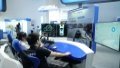 A staff member (R) demonstrates features of a vehicle safety simulation platform at an exhibition during the Global Digital Economy Conference.Photo by Xinhua/Ren Chao.