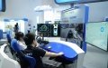 A staff member (R) demonstrates features of a vehicle safety simulation platform at an exhibition during the Global Digital Economy Conference.Photo by Xinhua/Ren Chao.