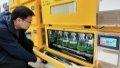 Ni Jun, a researcher at the School of Life Sciences and Biotechnology under the Shanghai Jiao Tong University, observes bottles filled with blue-green algae cells modified by gene editing in his lab in east China's Shanghai. Photo by Xinhua/Dong Xue.