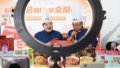 Staff members of Quanjude, one of China's best-known roast duck chain restaurants, sell products via a live show at the cultural and tourism services exhibition hall in the Shougang Park in Beijing. Photo by Xinhua/Ju Huanzong.