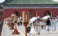 Tourists shield themselves from the sunshine with umbrellas at the Temple of Heaven in Beijing, capital of China. Photo by Xinhua/Ju Huanzong.