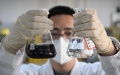 A researcher displays industrial wastewater and processed recycled water at the National Research Center of Industrial Water Treatment Engineering and Technology in north China's Tianjin. Photo by Xinhua/Sun Fanyue.