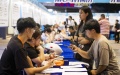 Job seekers inquire about job opportunities at a job fair for college graduates in Jinhua City, east China's Zhejiang Province. Photo by Shi Kuanbing/Xinhua.