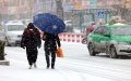 People walk on a street in the snow in Zaozhuang, east China's Shandong Province. Photo by Sun Zhongzhe/Xinhua.