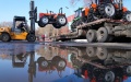 A staff member operates a forklift to load a tractor onto a truck at a tractor manufacturing company in Jiamusi, northeast China's Heilongjiang Province. Photo by Xinhua/Wang Jianwei.