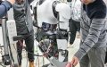 Researchers adjust a humanoid robot at an AI laboratory. Photo by Xinhua/Chen Yehua.
