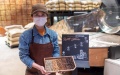 A staff member shows samples of raw and roasted coffee beans at the Starbucks Reserve Roastery in east China's Shanghai. Photo by Xinhua/Wang Xiang.