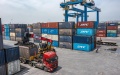 A truck transferring containers at the dry port of the New International Land-Sea Trade Corridor in southwest China's Chongqing Municipality. Photo by Xinhua/Huang Wei.