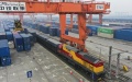 A rail-sea intermodal freight train carrying containers of goods, including cars, motorcycles, engines, and sodium carbonate, at Tuanjie Village Central Station in southwest China's Chongqing. Photo by Xinhua/Liu Chan.
