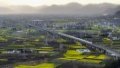 A passenger train running along the Xi'an-Chengdu high-speed railway in Yangchun Town of Nanzheng District in Hanzhong, northwest China's Shaanxi Province. Photo by Xinhua/Shao Rui.