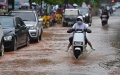 Citizens ride on a flooded street in Nanning, south China's Guangxi Zhuang Autonomous Region. Photo by Xinhua/Zhou Hua.