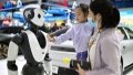 A girl interacts with an artificial intelligence robot at the fourth China International Consumer Products Expo in Haikou, capital city of south China's Hainan Province. Photo by Xinhua/Guo Cheng.
