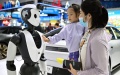 A girl interacts with an artificial intelligence robot at the fourth China International Consumer Products Expo in Haikou, capital city of south China's Hainan Province. Photo by Xinhua/Guo Cheng.