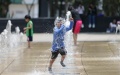 A kid refreshes himself at a fountain in Mexico City, Mexico. Photo by Francisco Canedo/Xinhua.