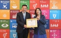 UN Under-Secretary-General for Global Communications Melissa Fleming presents President of Xinhua News Agency Fu Hua at the UN headquarters in New York. Photo by Xinhua/Li Rui.