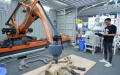 An employee of a Nanjing-based precision instrument company shows 3D printing technology. Photo by Xinhua/Li Renzi.
