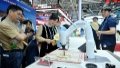 People watch as an AI-powered robotic arm writes with a brush at the hand-on experience area during the 7th Digital China Summit in Fuzhou, southeast China's Fujian Province. Photo by Xinhua/Lin Shanchuan.