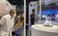 A staff member from the exhibition explains details of the lunar soil collected by the Chinese spacecraft Chang'e 5 to Thai visitors. Photo by Xinhua.