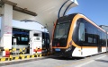 A medium-capacity hydrogen fuel cell-powered public bus (R) approaches a hydrogen refueling station in Lingang new area of Pudong New Area in east China's Shanghai. Photo by Xinhua/Fang Zhe.