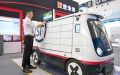An exhibitor operates an unmanned autonomous delivery vehicle for courier service displayed at the World Intelligence Expo 2024 in north China's Tianjin. Photo by Xinhua/Sun Fanyue.
