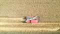A reaper harvesting wheat in the farmland in Guanghan City, southwest China's Sichuan Province. Photo by Xinhua/Yang Jin.