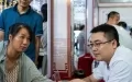 A medical worker (R) takes a citizen's pulse at a night traditional Chinese medicine clinic in Changning City, central China's Hunan Province. Photo by Xinhua/Chen Sihan.