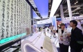 A staff member introduces the use of AIGC technology in ancient book restoration to a visitor during the 2024 World AI Conference in Shanghai, east China. Photo by Xinhua/Fang Zhe.