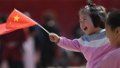 A child holding a Chinese national flag enjoys herself at a wetland park in Xigang Town, Tengzhou City of east China's Shandong Province. Photo by Li Zhijun/Xinhua.