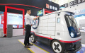 An exhibitor operates an unmanned autonomous delivery vehicle for courier service displayed at the World Intelligence Expo 2024 in north China's Tianjin. Photo by Xinhua/Sun Fanyue.