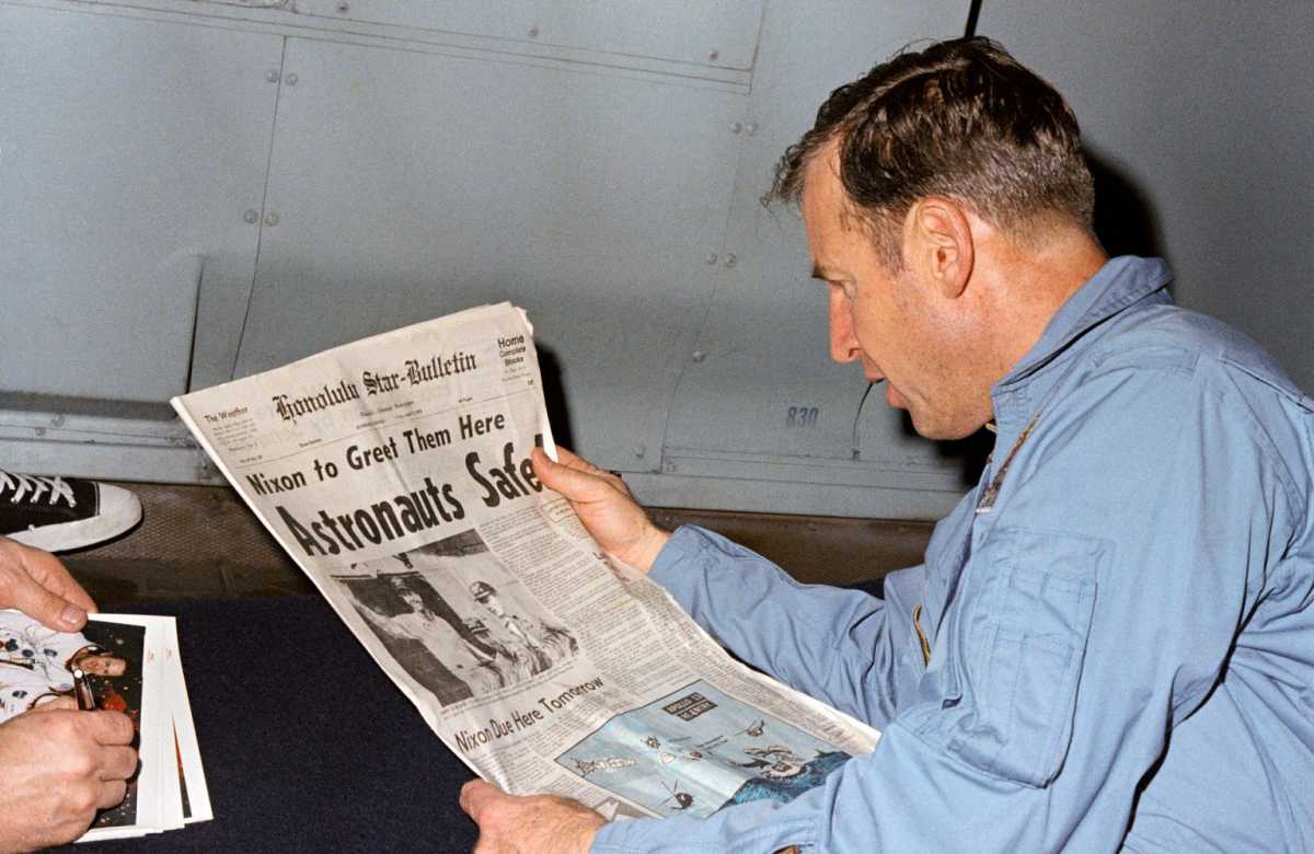 James Lovell, who returned to Earth, reads newspaper that tells about rescue of Apollo 13 crew. Source: NASA