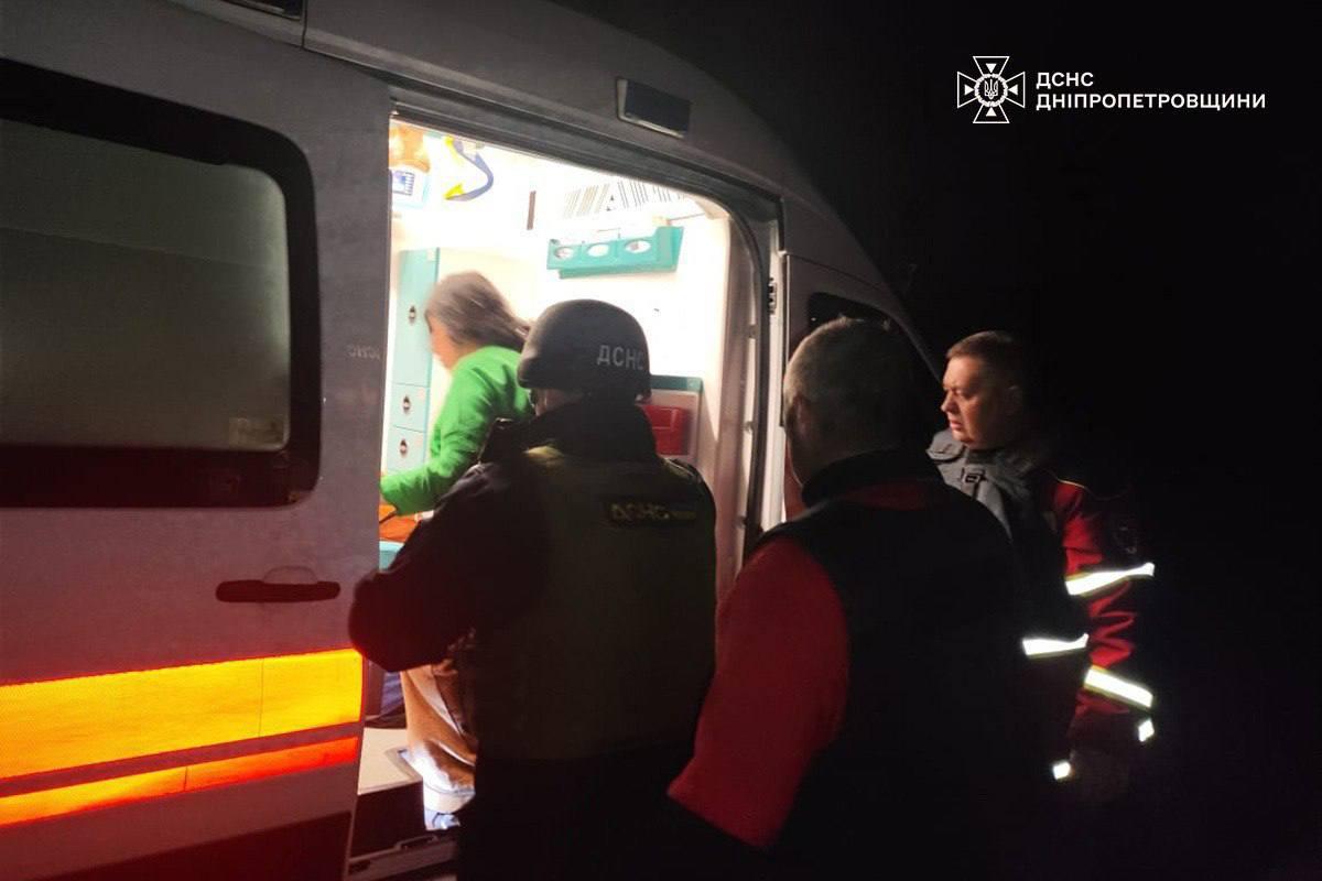 Rescuers and doctors provide assistance to an injured woman. Photo: SES