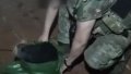 Soldiers remove a dog from a bag after it was evacuated by UAV. Photo: screenshot.