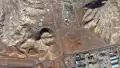 This satellite image shows a tunnel complex carved into rocky terrain near a built-up area in Isfahan, Iran. Photo: Maxar/DigitalGlobe.
